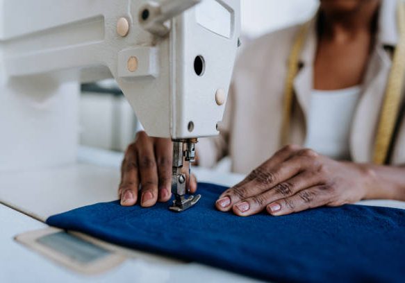 Unrecognizable person sewing using sewing machine